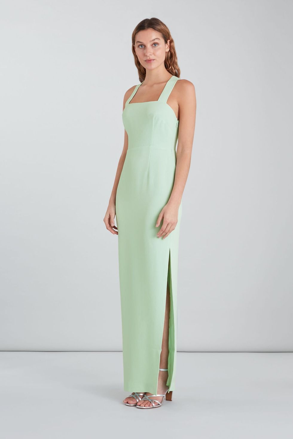 model wearing mint green floor length 90s strap style dress with silver strappy sandals