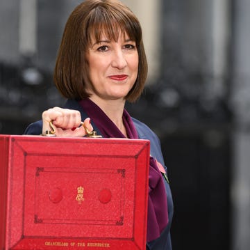 A person holding a red briefcase symbolizing a financial or governmental context A person holding a red briefcase symbolizing a financial or governmental context