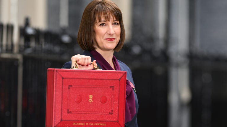 A person holding a red briefcase symbolizing a financial or governmental context