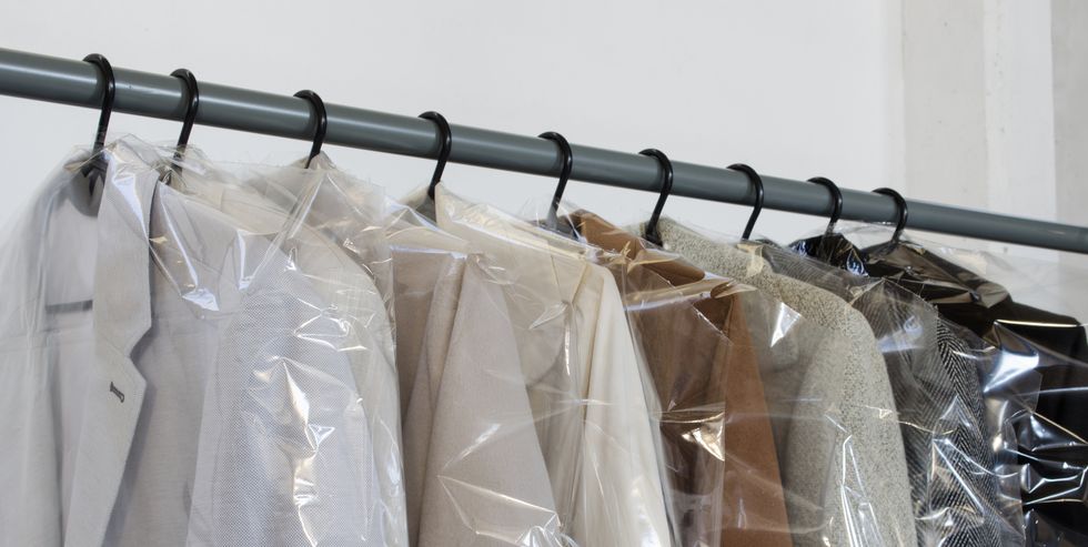 rack with clean coats after dry cleaning on a dry cleaner quality laundry service hangers row winter season