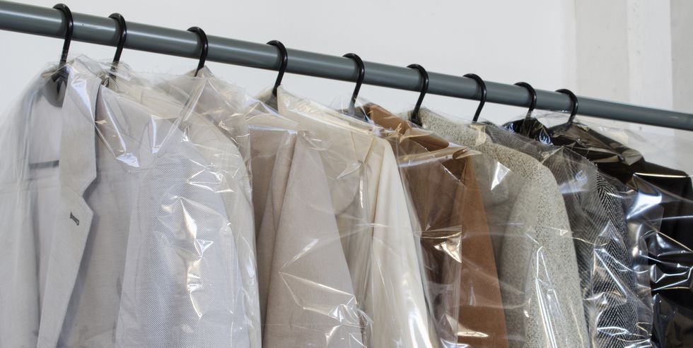 rack with clean coats after dry cleaning on a dry cleaner quality laundry service hangers row winter season