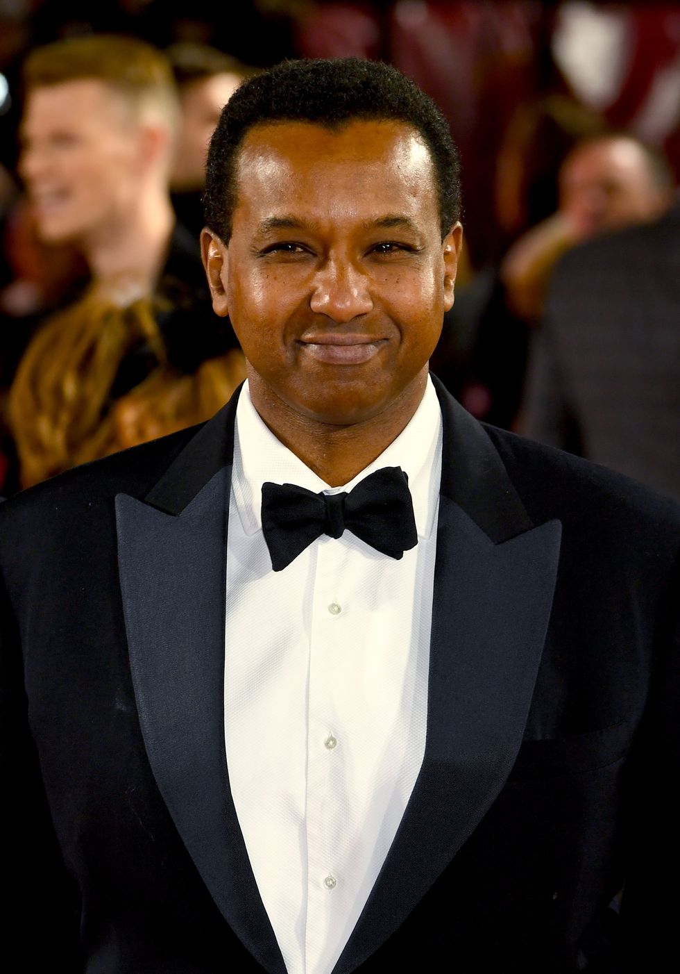 rageh omaar attends an event in 2019, wearing a tuxedo and bow tie