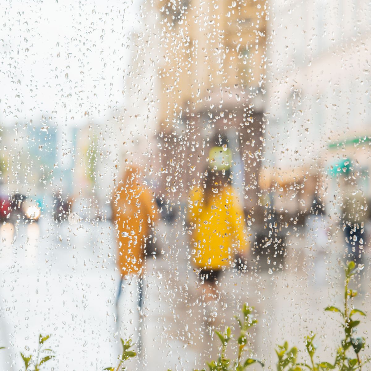 rain on a window, looking out to people in a street scene