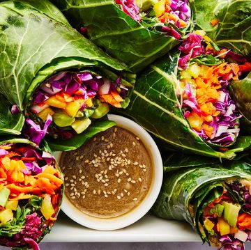 collard green wrap filled with shredded purple cabbage, grated carrots, yellow bell pepper, avocado, alfalfa sprouts and red sauerkraut