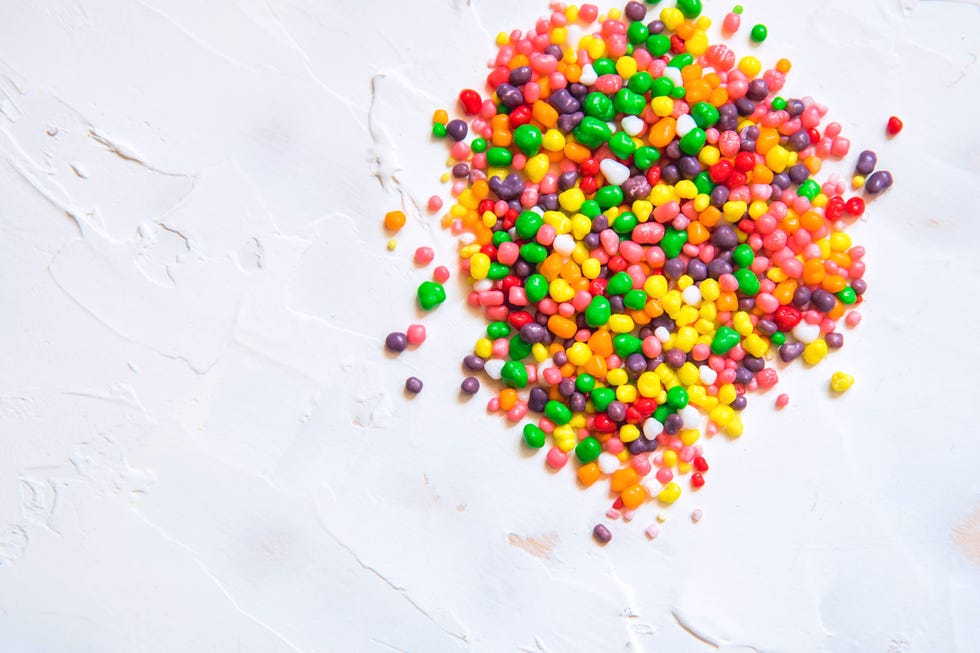 rainbow colored candy nerds sprinkled on a white background