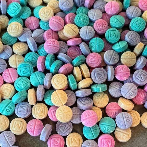 rainbow fentanyl candylike pink, green, yellow, purple pill tablets