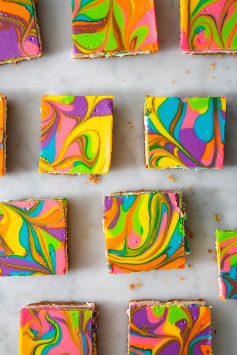 rainbow cheesecake bars on a marble background