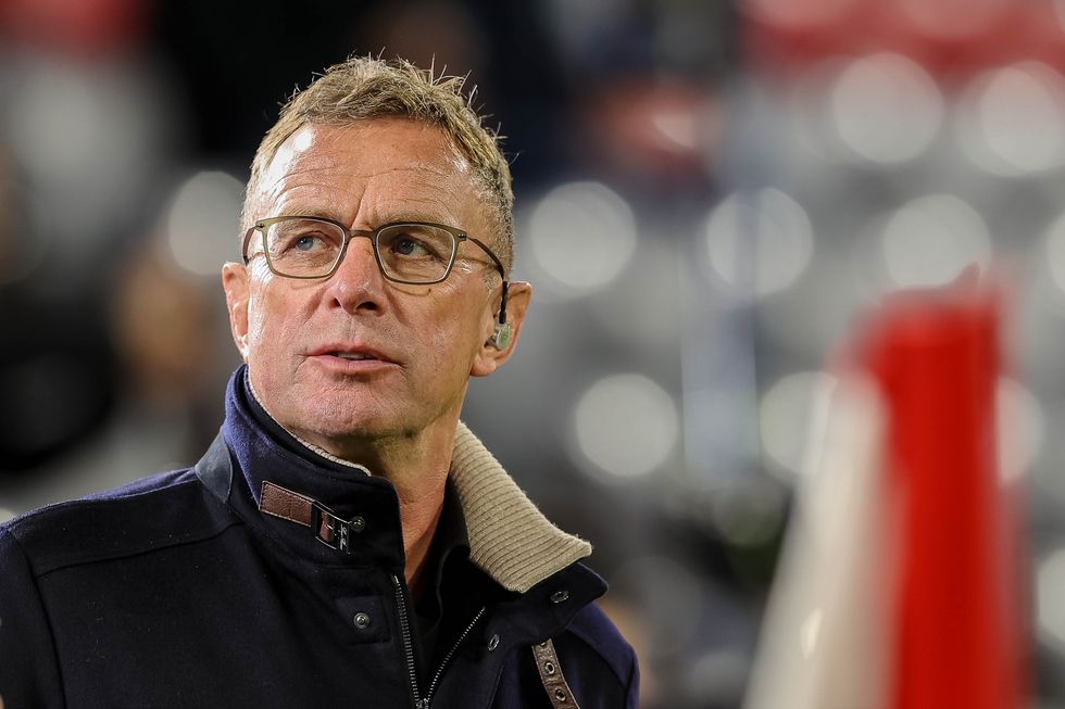 the football coach ralf rangnick looks at the pitch from the touchline during a game at night