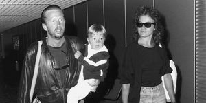 Eric Clapton singer songwriter and girlfriend Lori Del Santo walk through airport with son Conor