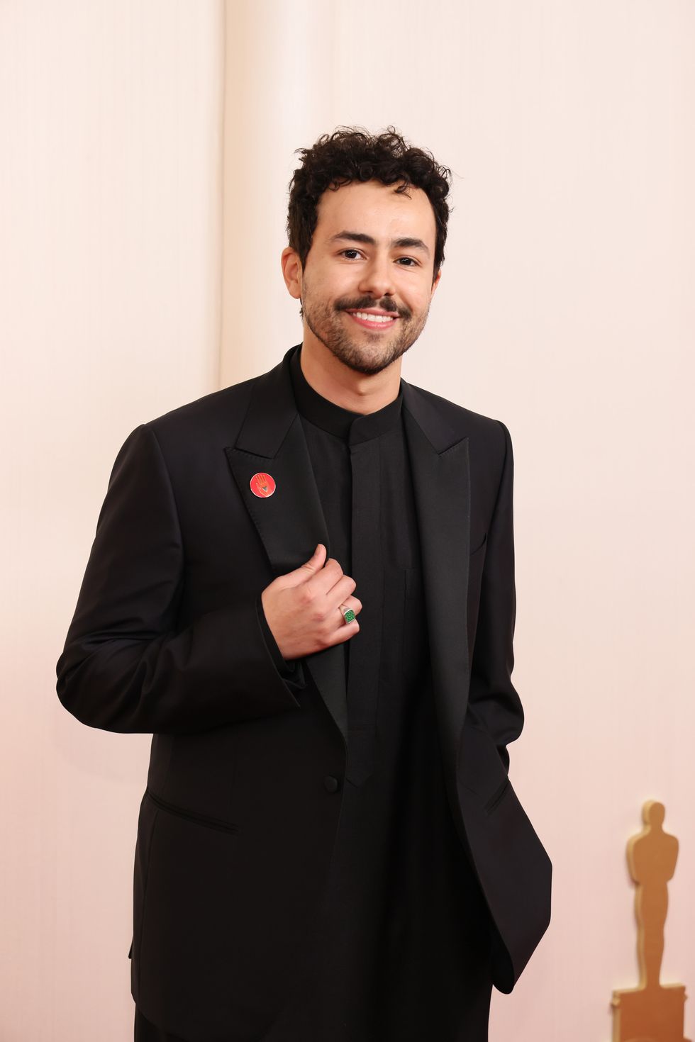 Poor Things star Ramy Youssef explains wearing a red pin at the Oscars