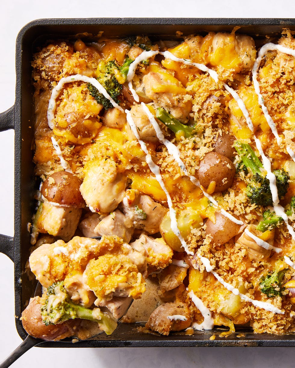 chicken with potatoes, broccoli, melted cheese, and drizzled with ranch in a casserole dish