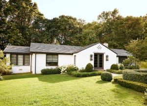 a white ranch style house with gray roof