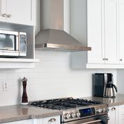 kitchen with stainless steel range hood over stove
