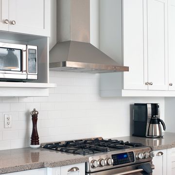 kitchen with stainless steel range hood over stove