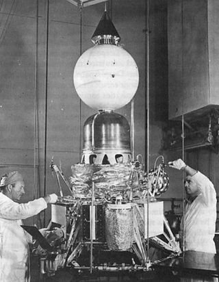 nasa technicians tinkering with the ranger black 2 spacecraft, which contained a seismometer encased in a sphere of balsawood ﻿