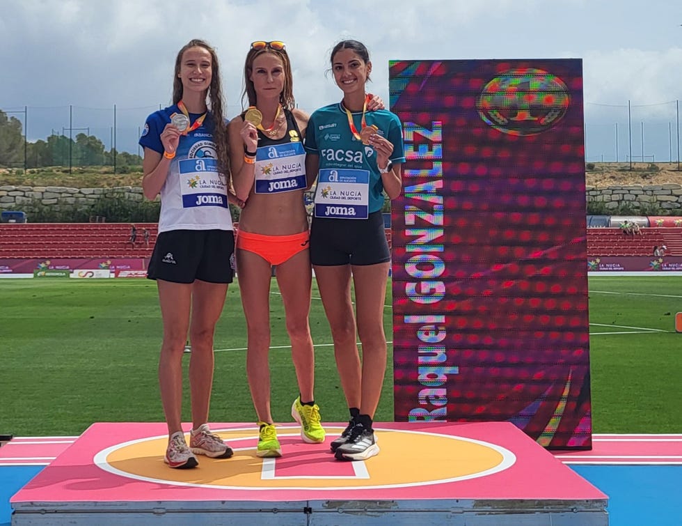 a group of women posing for a picture on a podium