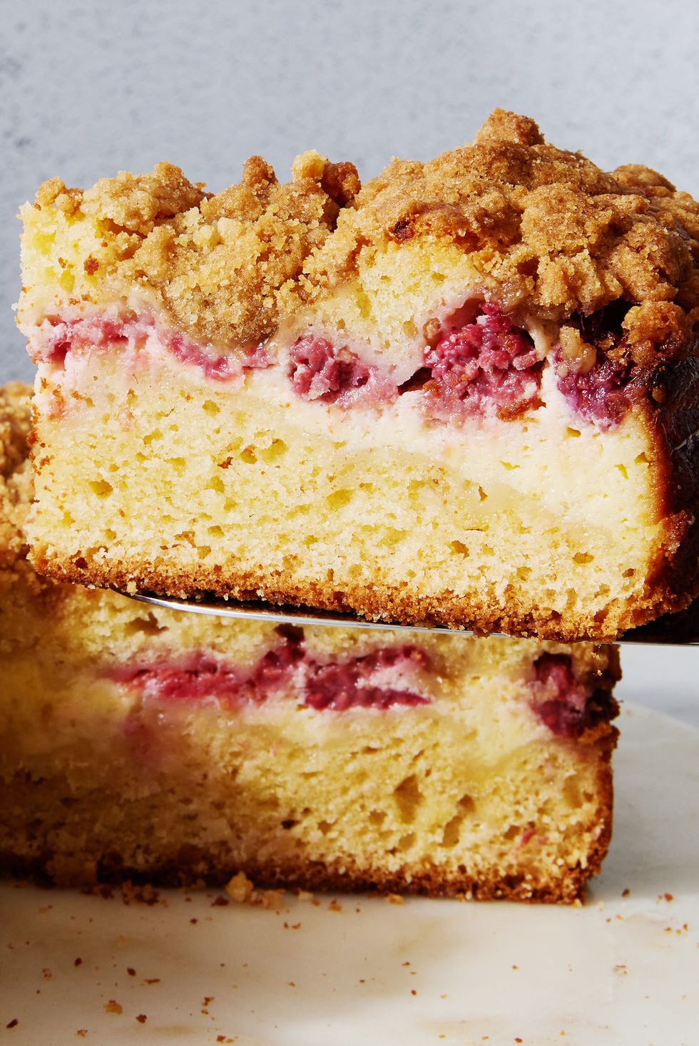 coffee cake with layered of raspberry and cream cheese with a crumble topping