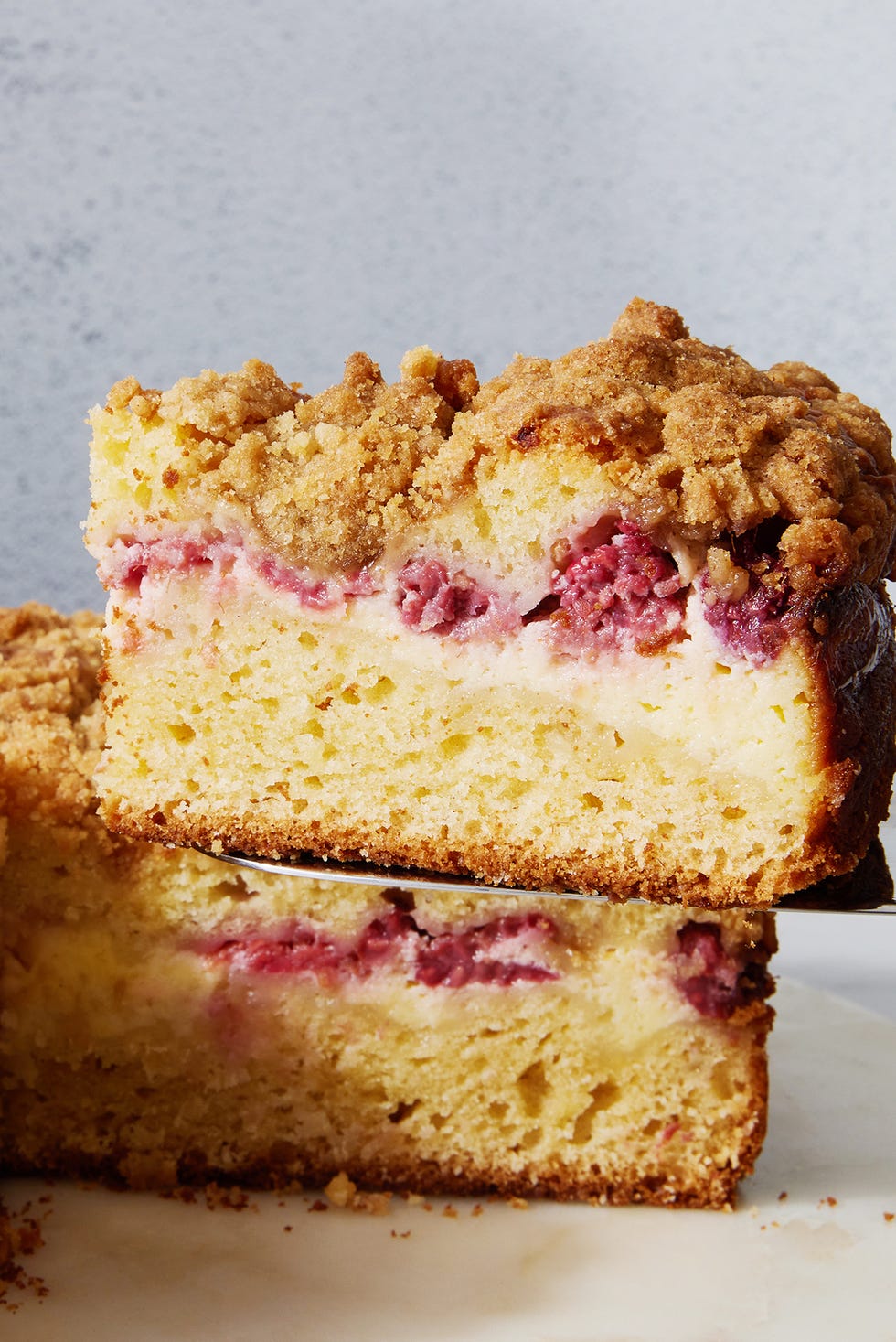 coffee cake with layered of raspberry and cream cheese with a crumble topping