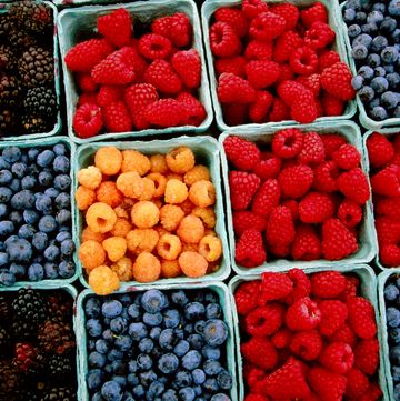 raspberry, blueberry and blackberry punnets at farmers market.