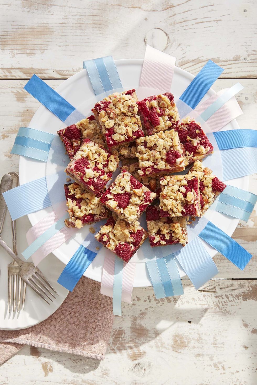 raspberry crumb bars on platter with ribbons