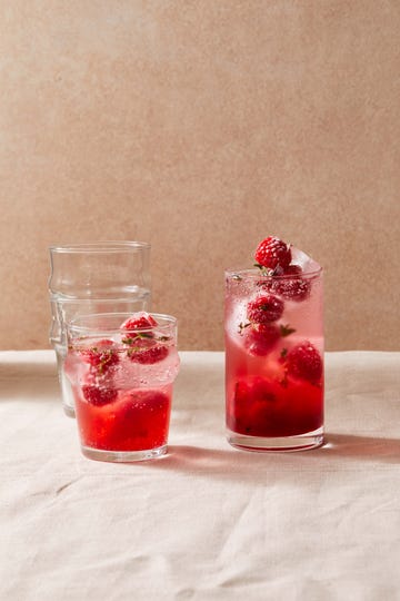 pink cocktails 2 glasses of sparkling raspberry hibiscus mocktails with raspberry thyme ice cubes