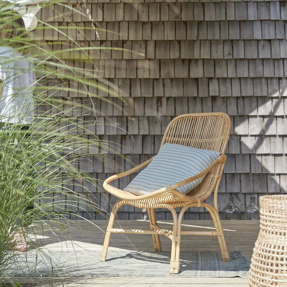 a chair outside by a wall