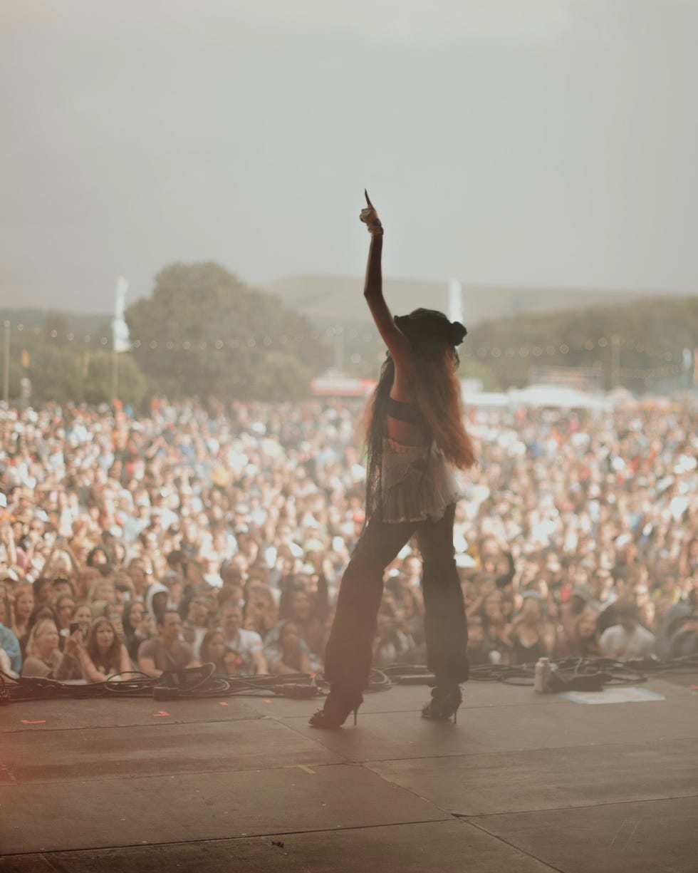 performer engaging with a large crowd at a concert