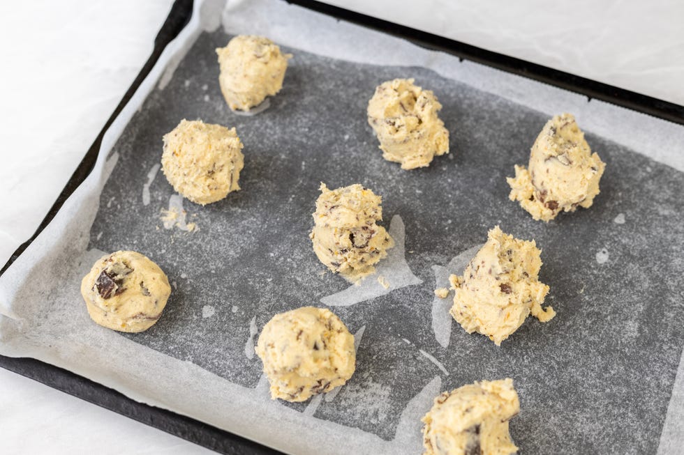 raw crisp cookies prepared for baking on baking tray