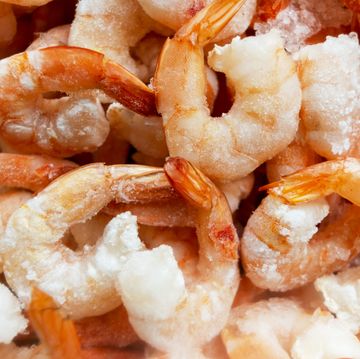 raw frozen and peeled shrimp background pile of frozen shrimps  close up of frozen shrimps a lot of royal shrimp macro shot