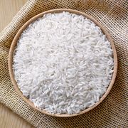 raw, parboiled rice in a wooden bowl