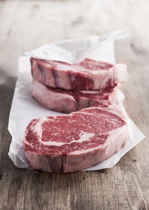 raw rib eye steaks on butcher paper