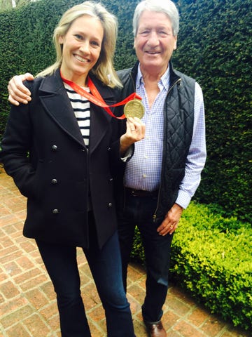 sophie raworth hold a medal while standing next to her father