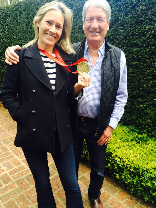 sophie raworth hold a medal while standing next to her father