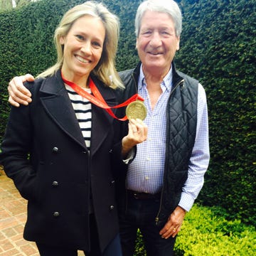 sophie raworth hold a medal while standing next to her father sophie raworth hold a medal while standing next to her father