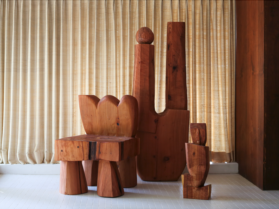 a set of wooden furniture and sculptures