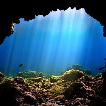 rays of light at underwater cave entrance