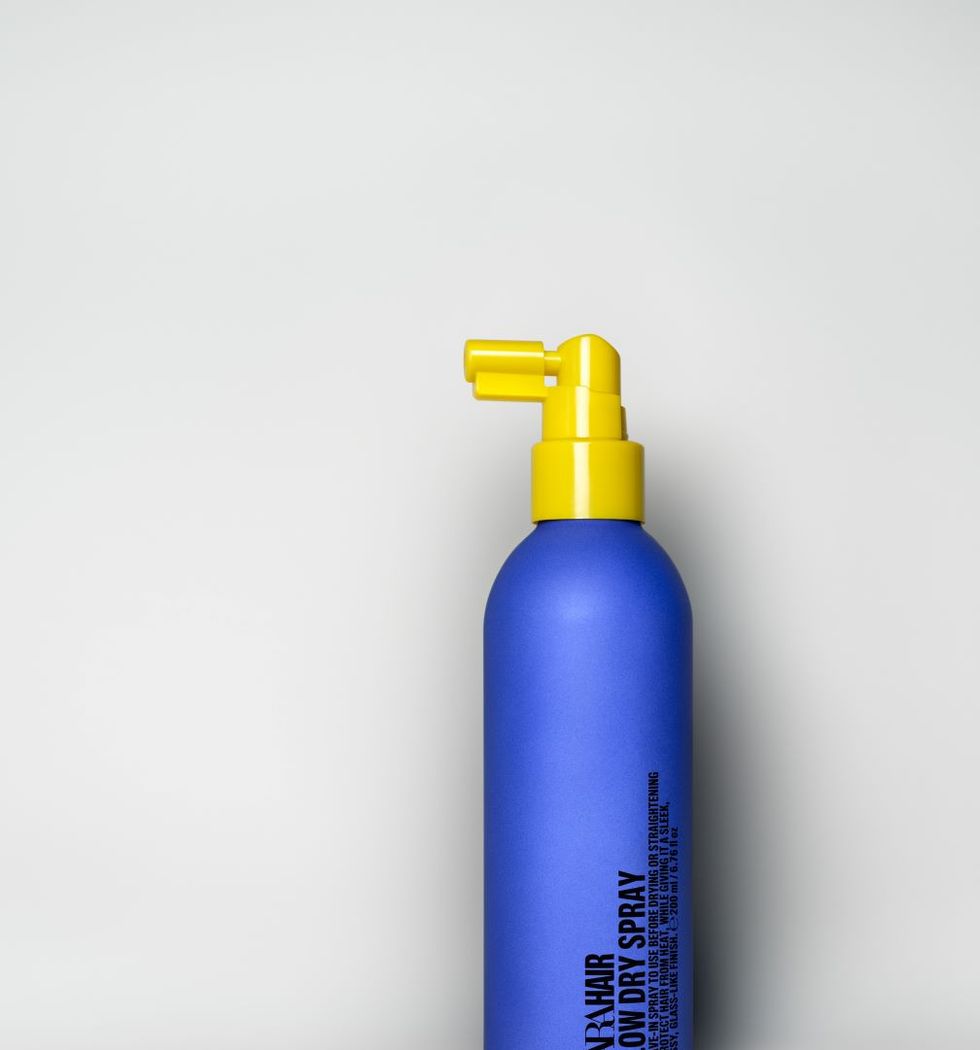 a blue bottle with a yellow cap
