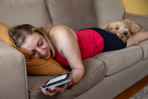 reading a book with goldendoodle at home