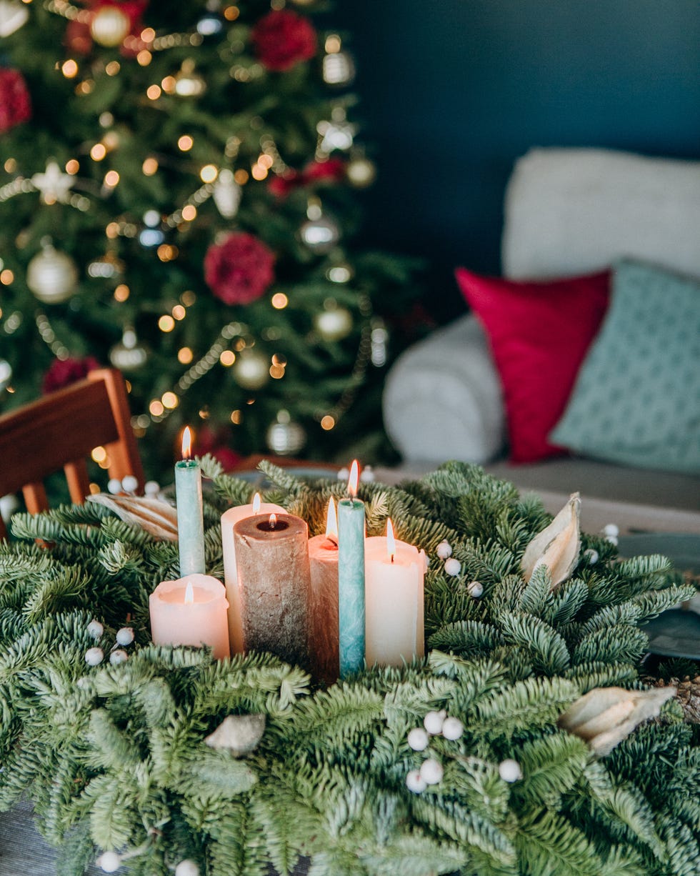 festive decorations and table setting inside the room with the christmas tree and garlands