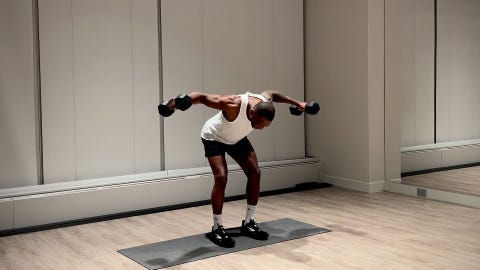 shoulder and arm workout, yusuf jeffers practicing rear delt fly exercise
