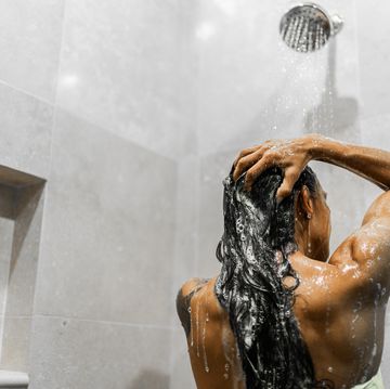 rear view of a woman taking a shower in the bathroom
