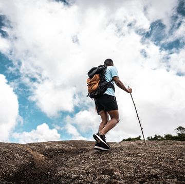 rear view of a young man doing a trail on a mountain