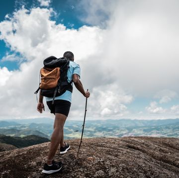 rear view of a young man doing a trail on a mountain