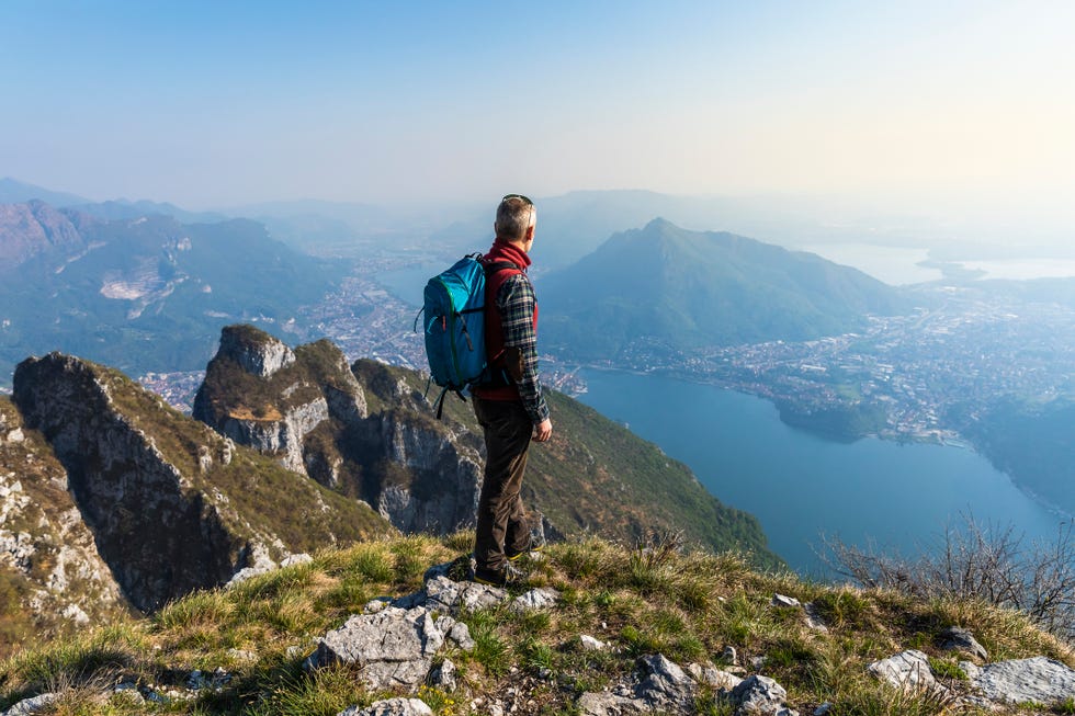 rear view of hiker on mountaintop, orobie alps, lecco, italy