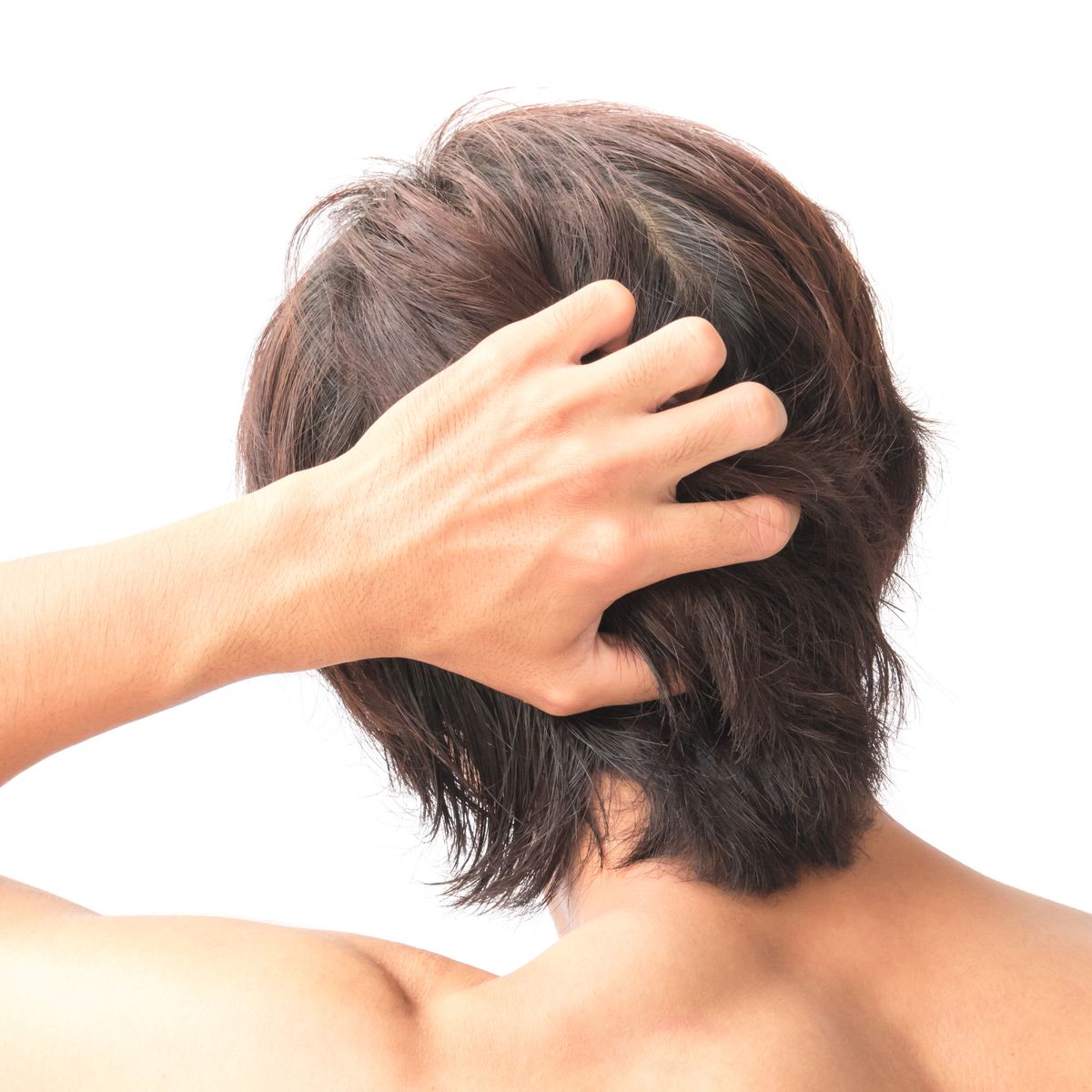Rear View Of Man Touching Hair Over White Background