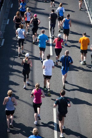 Rear view of people running in a marathon