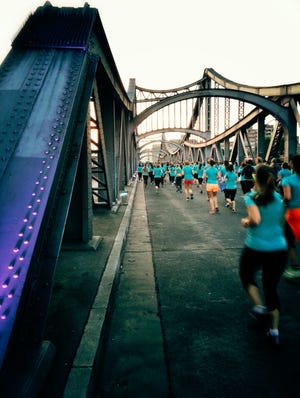 rear view of people running on bridge at prenzlauer berg