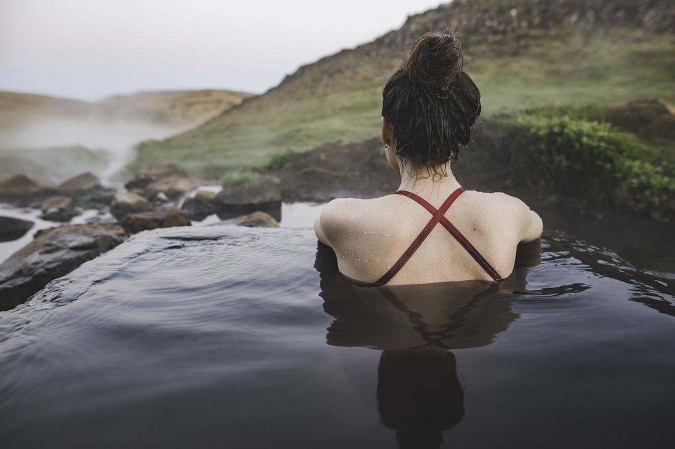rear view of woman in hot pool iceland