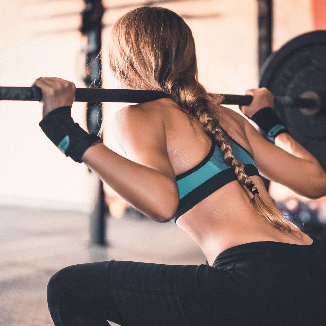 https://hips.hearstapps.com/hmg-prod/images/rear-view-of-woman-lifting-weights-in-gym-royalty-free-image-1573129358.jpg?crop=0.680xw:0.893xh;0.168xw,0.0179xh&resize=2048:*