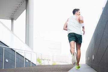 rear view of young man jogging in the city